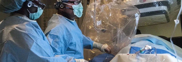 Cardiology staff performing a STEMI catheterization procedure in a hospital catheterization laboratory.