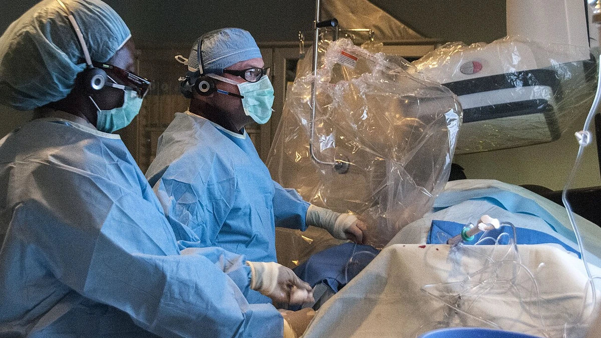 Cardiology staff performing a STEMI catheterization procedure in a hospital catheterization laboratory.