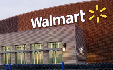 Exterior of a Walmart store with the Walmart logo on the building.
