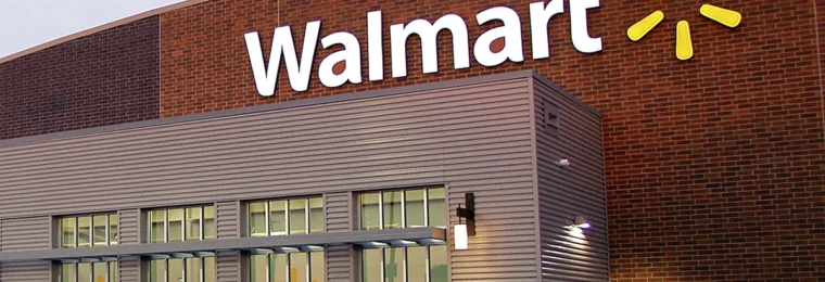 Exterior of a Walmart store with the Walmart logo on the building.