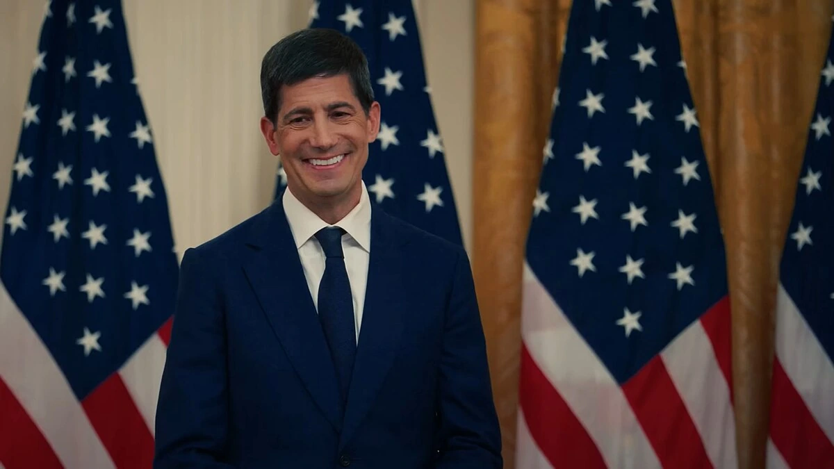 Federal Reserve Chair Kevin Warsh standing in front of U.S. flags.