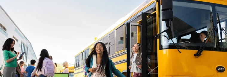 Zūm-branded school bus with students and staff.