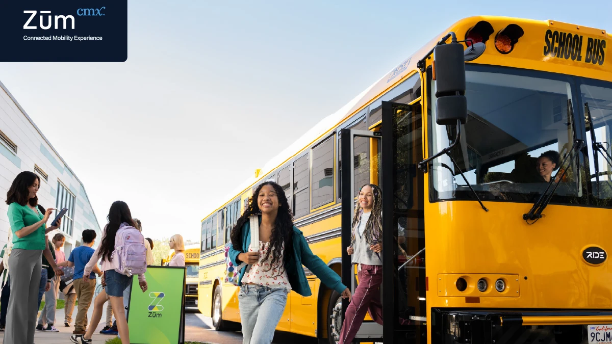 Zūm-branded school bus with students and staff.