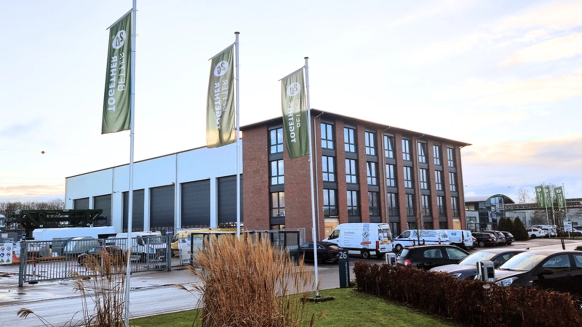 2G Energy headquarters and production building in Heek, Germany, with company flags in the foreground.