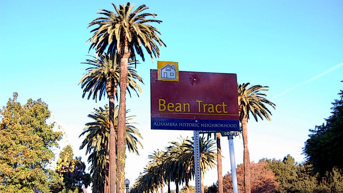 Bean Tract historic neighborhood sign along a palm-lined street in Alhambra, California.