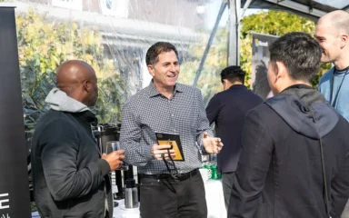 Michael Dell speaking with attendees at an outdoor event in 2021.
