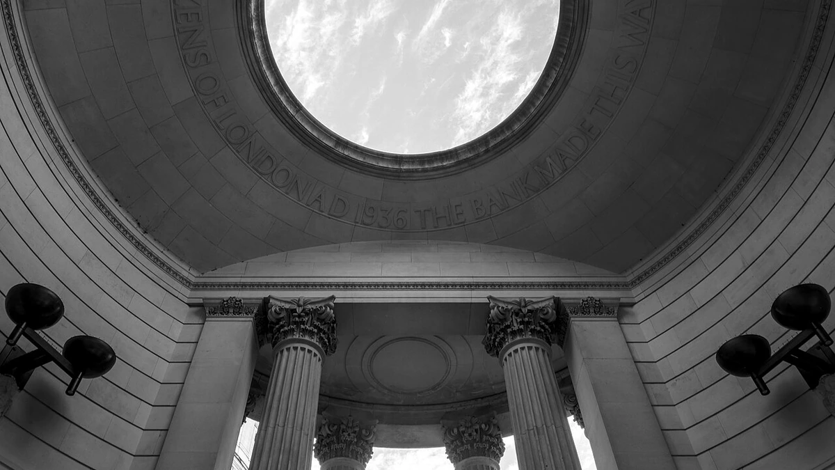 Black-and-white view looking up at columns and an archway at the Bank of England Museum in London.