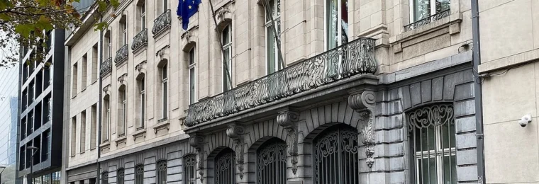 Belgian and European Union flags outside the building at Avenue des Arts 30 in Brussels.