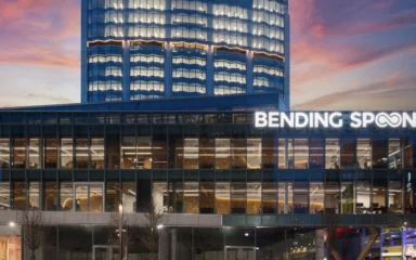 Bending Spoons headquarters in Milan with illuminated company signage.