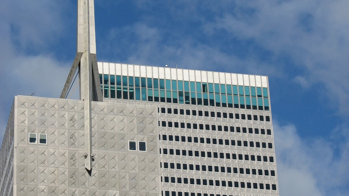 Upper portion of Republic Center in Dallas with its tower spire against a blue sky.