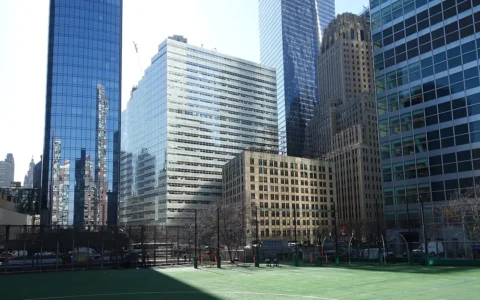 Lower Manhattan view from Battery Park City, with 240 Greenwich Street, BNY’s headquarters, visible in the background.