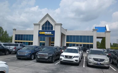 CarMax dealership building and used vehicles in Carmel, Indiana.