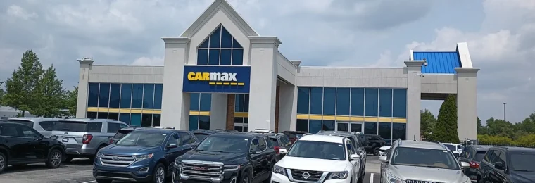 CarMax dealership building and used vehicles in Carmel, Indiana.