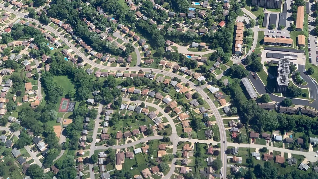Aerial view of winding streets and homes in a U.S. suburban neighborhood.