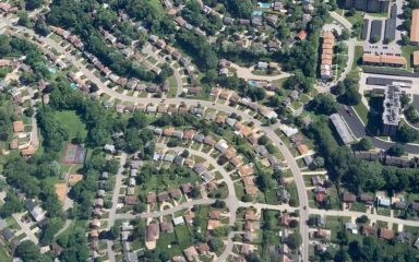Aerial view of winding streets and homes in a U.S. suburban neighborhood.