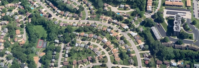 Aerial view of winding streets and homes in a U.S. suburban neighborhood.