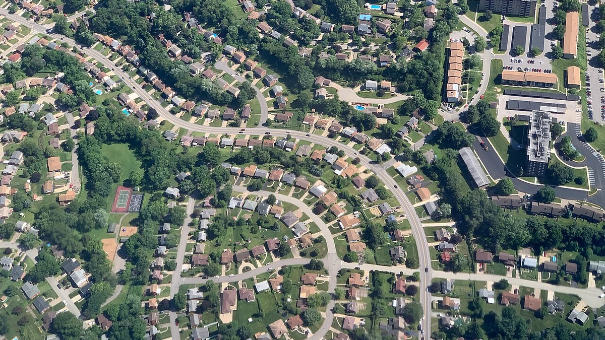 Aerial view of winding streets and homes in a U.S. suburban neighborhood.