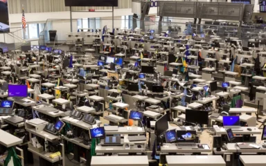 Trading floor inside the Chicago Board of Trade Building, with Cboe-branded screens visible among trading desks.