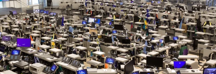 Trading floor inside the Chicago Board of Trade Building, with Cboe-branded screens visible among trading desks.