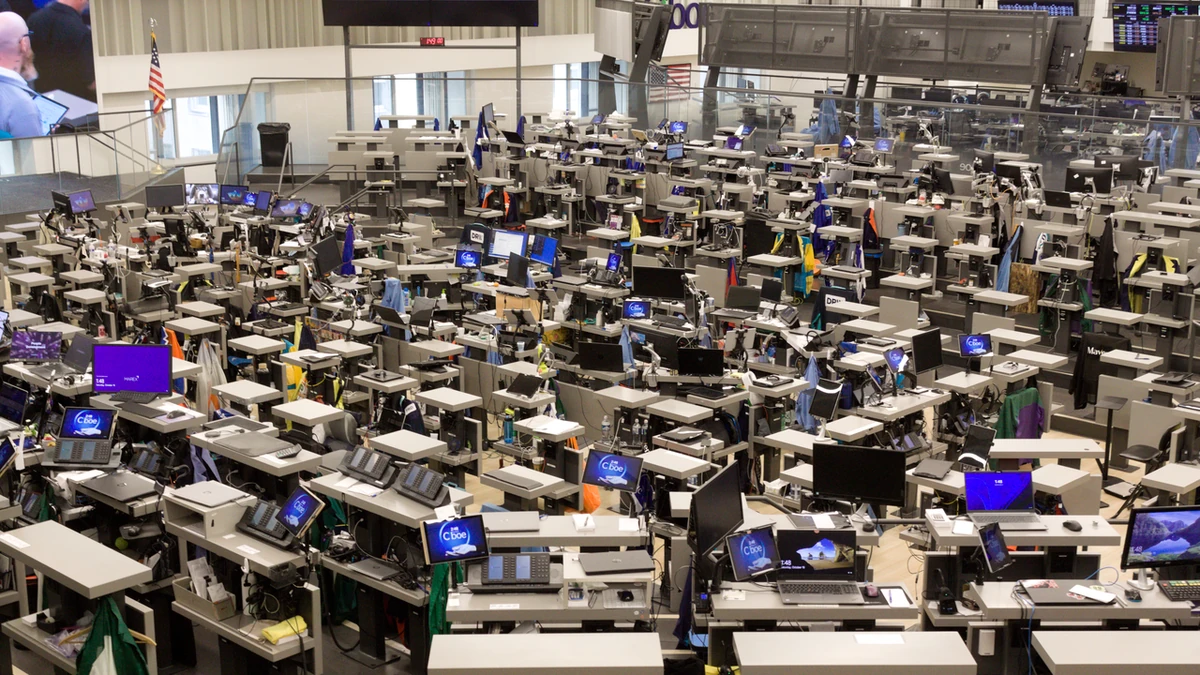 Trading floor inside the Chicago Board of Trade Building, with Cboe-branded screens visible among trading desks.