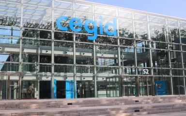 Cegid building in Lyon, France, with the company’s blue logo on the glass facade.