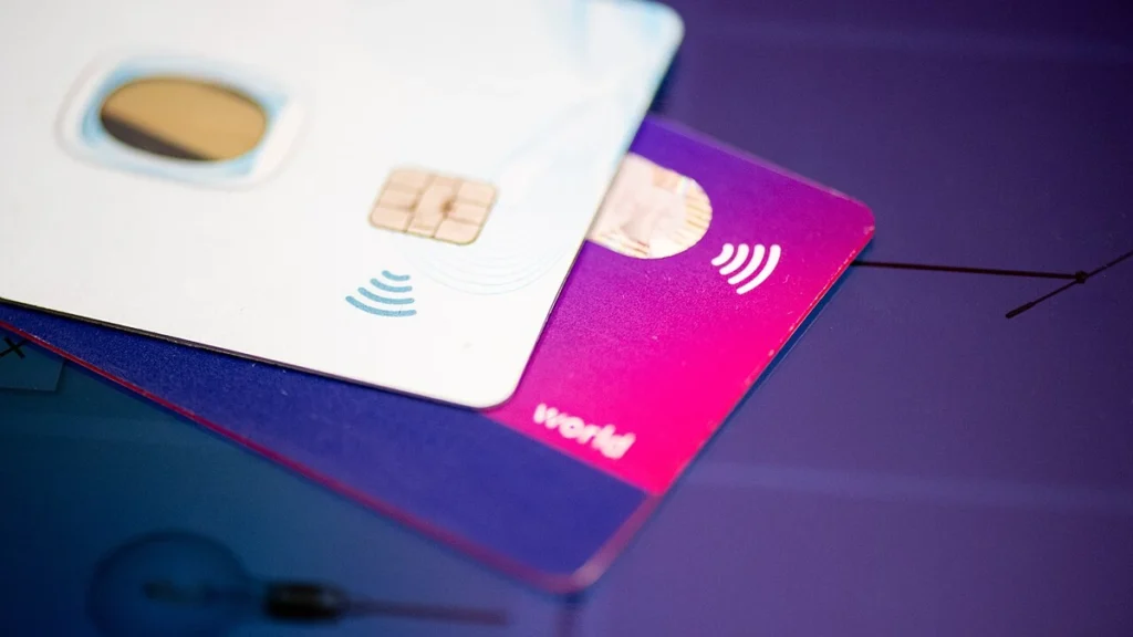 Contactless payment cards stacked on a surface.
