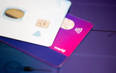 Contactless payment cards stacked on a surface.