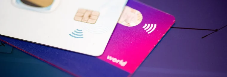 Contactless payment cards stacked on a surface.