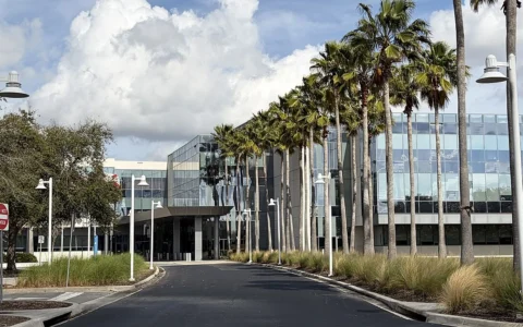 Darden Restaurants headquarters building near Orlando, Florida, with palm trees along the entrance.