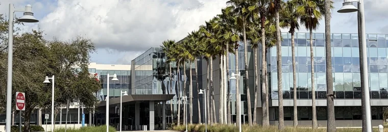 Darden Restaurants headquarters building near Orlando, Florida, with palm trees along the entrance.