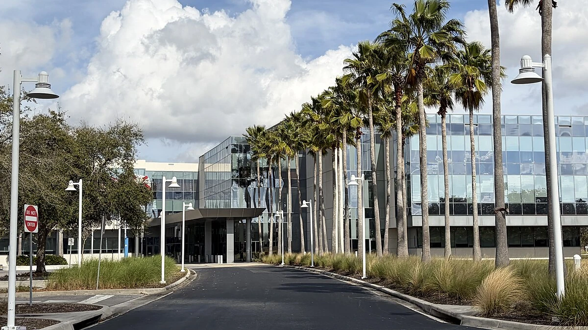 Darden Restaurants headquarters building near Orlando, Florida, with palm trees along the entrance.