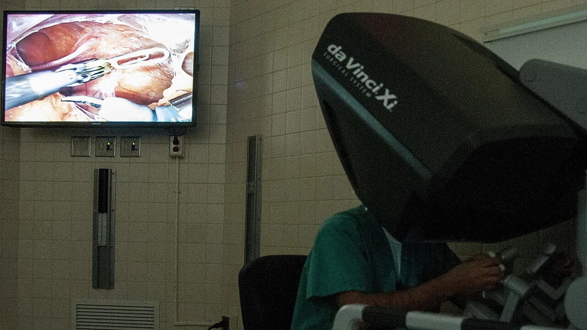 Surgeon using a 3D imaging console during robotic-assisted surgery.