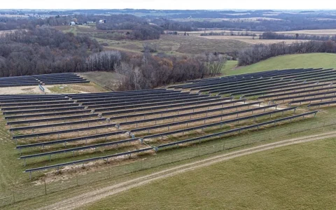 Solar panel arrays across rolling farmland in Wheatland, Wisconsin.