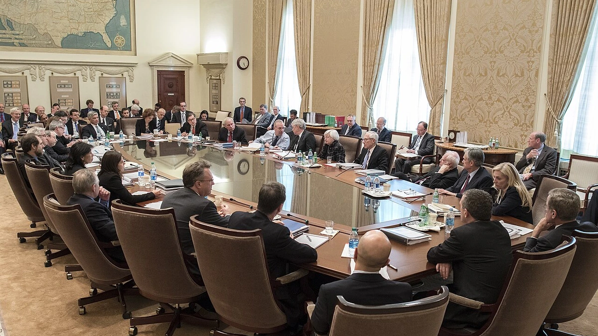 Federal Open Market Committee participants seated around a conference table at the Federal Reserve Board in Washington.