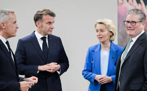 Mark Carney and Emmanuel Macron standing with Ursula von der Leyen and Keir Starmer in Johannesburg in November 2025.