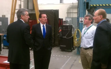 People standing inside FuelCell Energy's manufacturing facility in Torrington, Connecticut.
