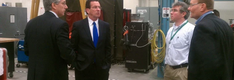 People standing inside FuelCell Energy's manufacturing facility in Torrington, Connecticut.