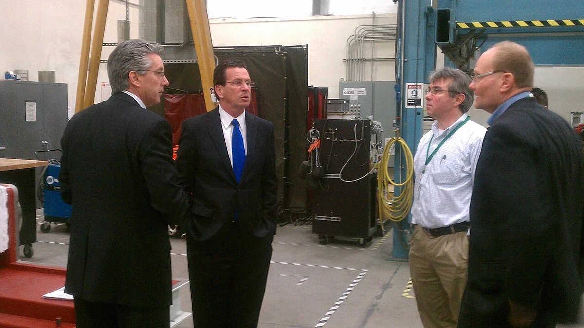 People standing inside FuelCell Energy's manufacturing facility in Torrington, Connecticut.
