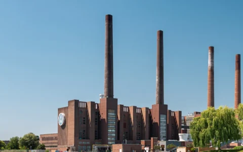 Volkswagen plant buildings and smokestacks in Wolfsburg, Germany.