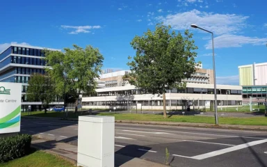 Grünenthal corporate campus in Aachen-Eilendorf, Germany, with company signage in the foreground.