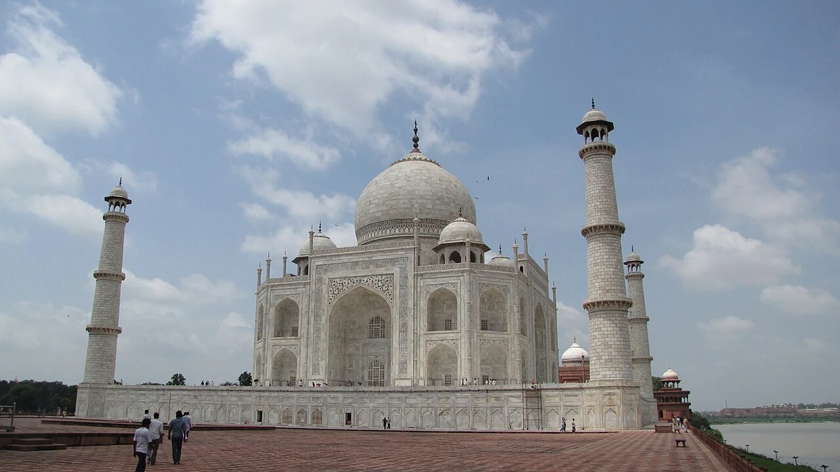 The Taj Mahal in Agra, India, beneath a partly cloudy sky.