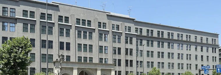Japan Ministry of Finance headquarters building in Tokyo under a clear blue sky.