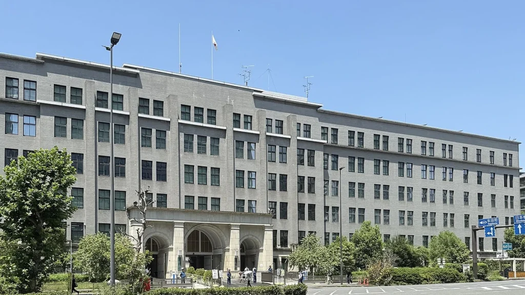Japan Ministry of Finance headquarters building in Tokyo under a blue sky.