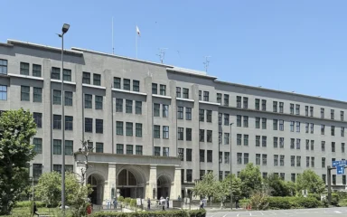 Japan Ministry of Finance headquarters building in Tokyo under a blue sky.