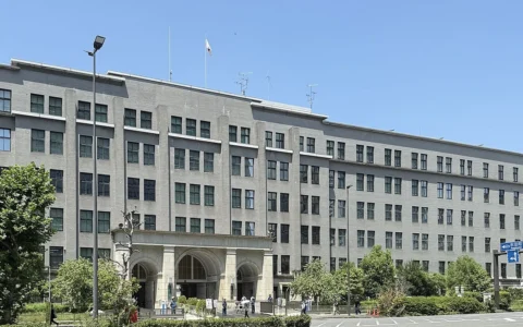 Japan Ministry of Finance headquarters building in Tokyo under a blue sky.