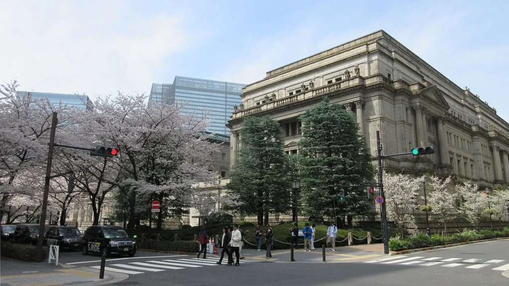 Bank of Japan headquarters in Tokyo with cherry blossoms in the foreground.