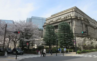 Bank of Japan headquarters in Tokyo with cherry blossoms in the foreground.