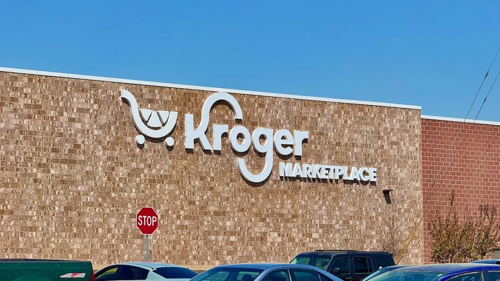 Exterior wall of a Kroger Marketplace store in Athens, Georgia, with Kroger signage and parked cars.