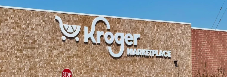 Exterior wall of a Kroger Marketplace store in Athens, Georgia, with Kroger signage and parked cars.