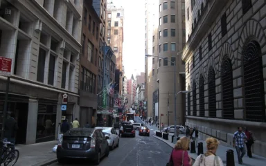 Nassau Street in Lower Manhattan alongside the Federal Reserve Bank of New York building.